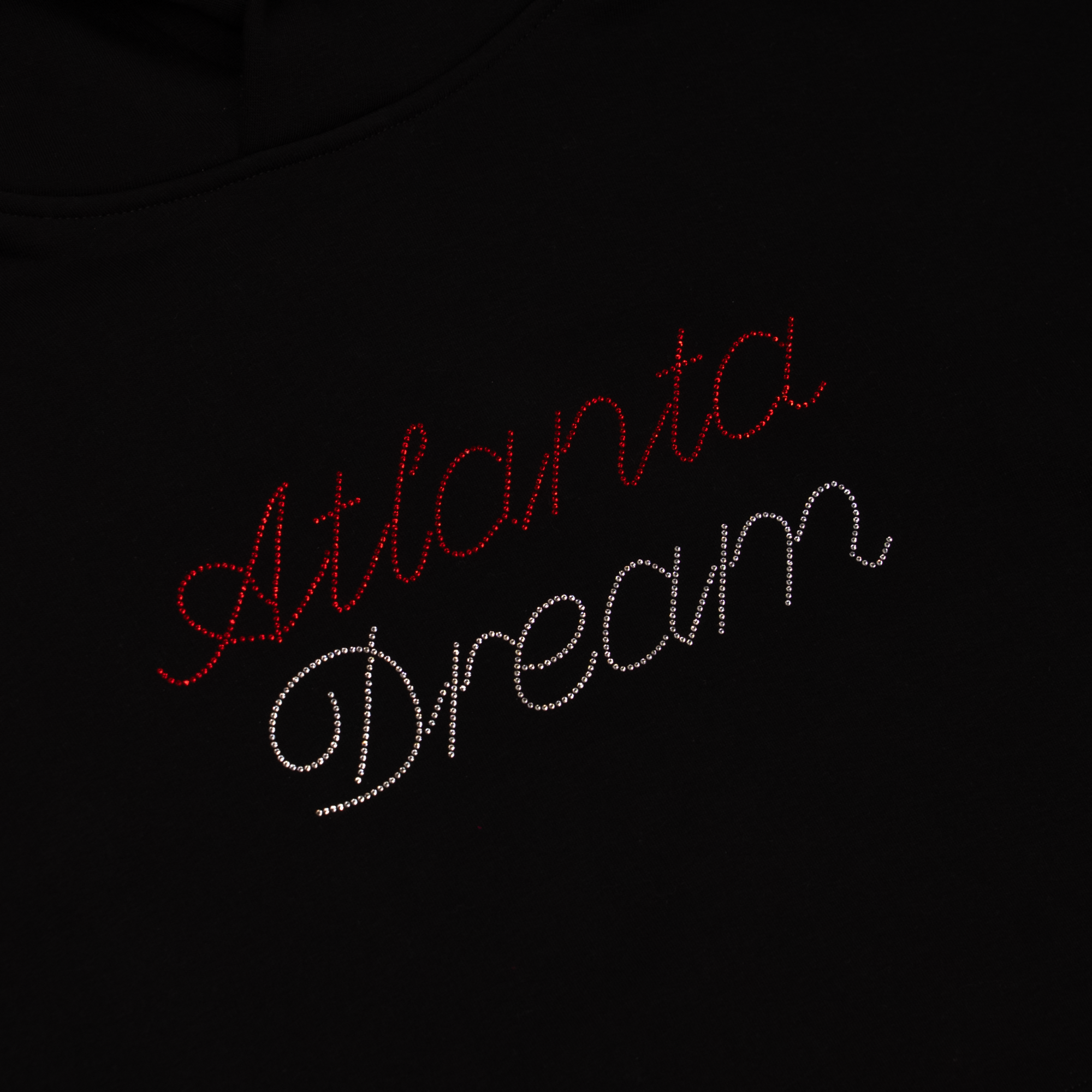 Black shirt with 'Atlanta Dream' text in red and white rhinestones