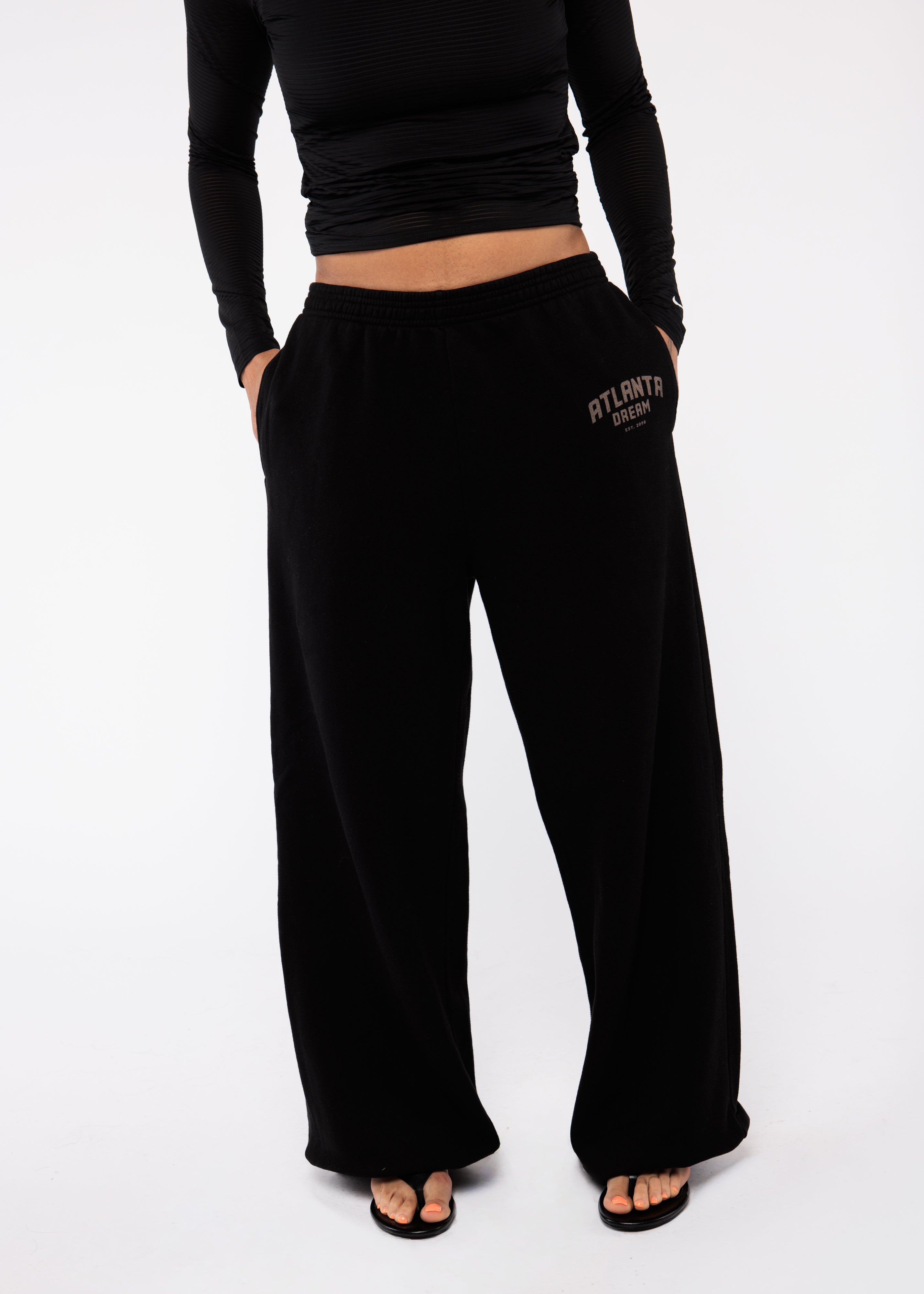Person wearing black sweatpants with 'Atlanta Strong' text 