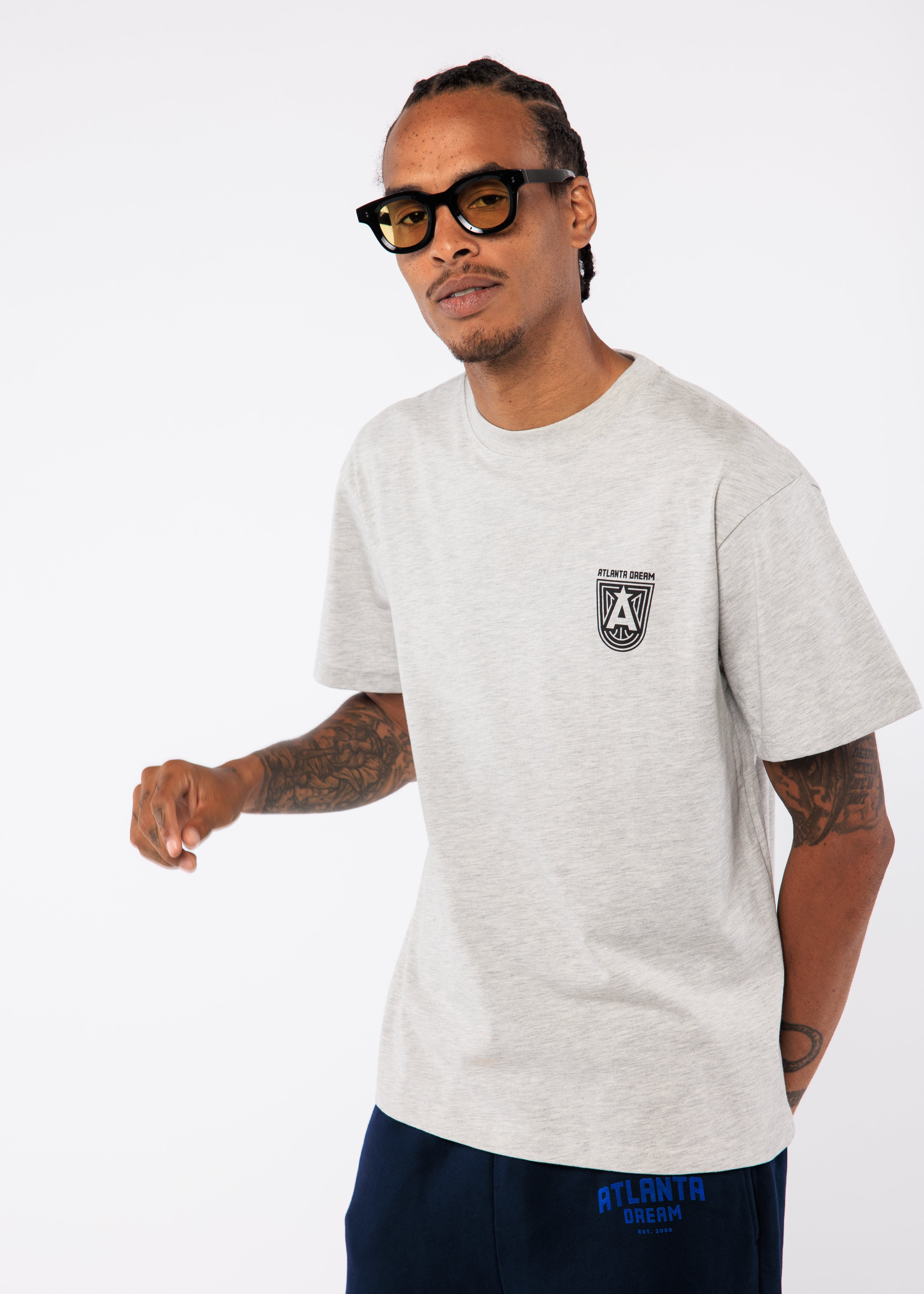 Wearing a gray t-shirt with a logo