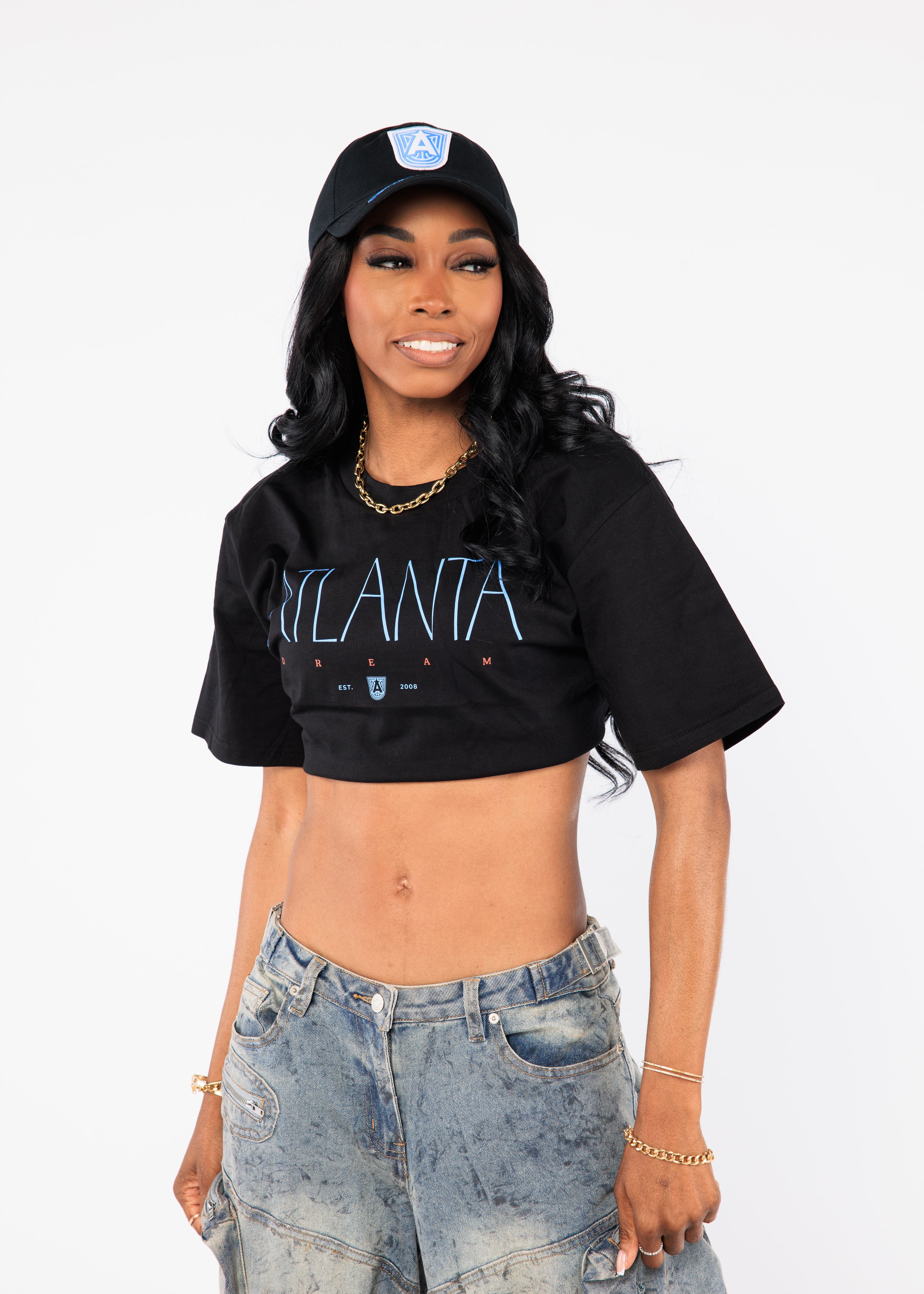 Wearing a black 'Atlanta' crop top and cap