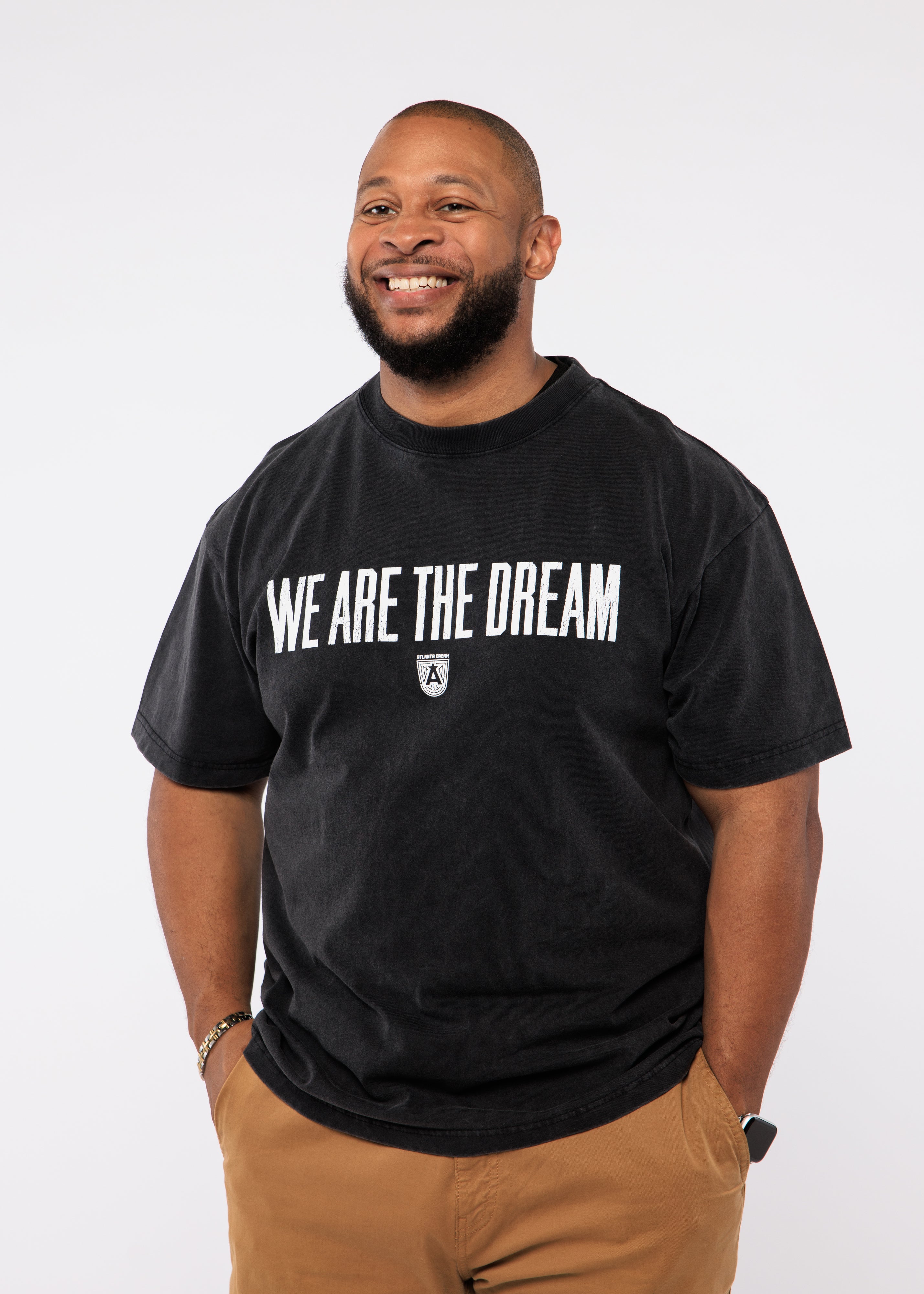 Wearing a black t-shirt with 'WE ARE THE DREAM'