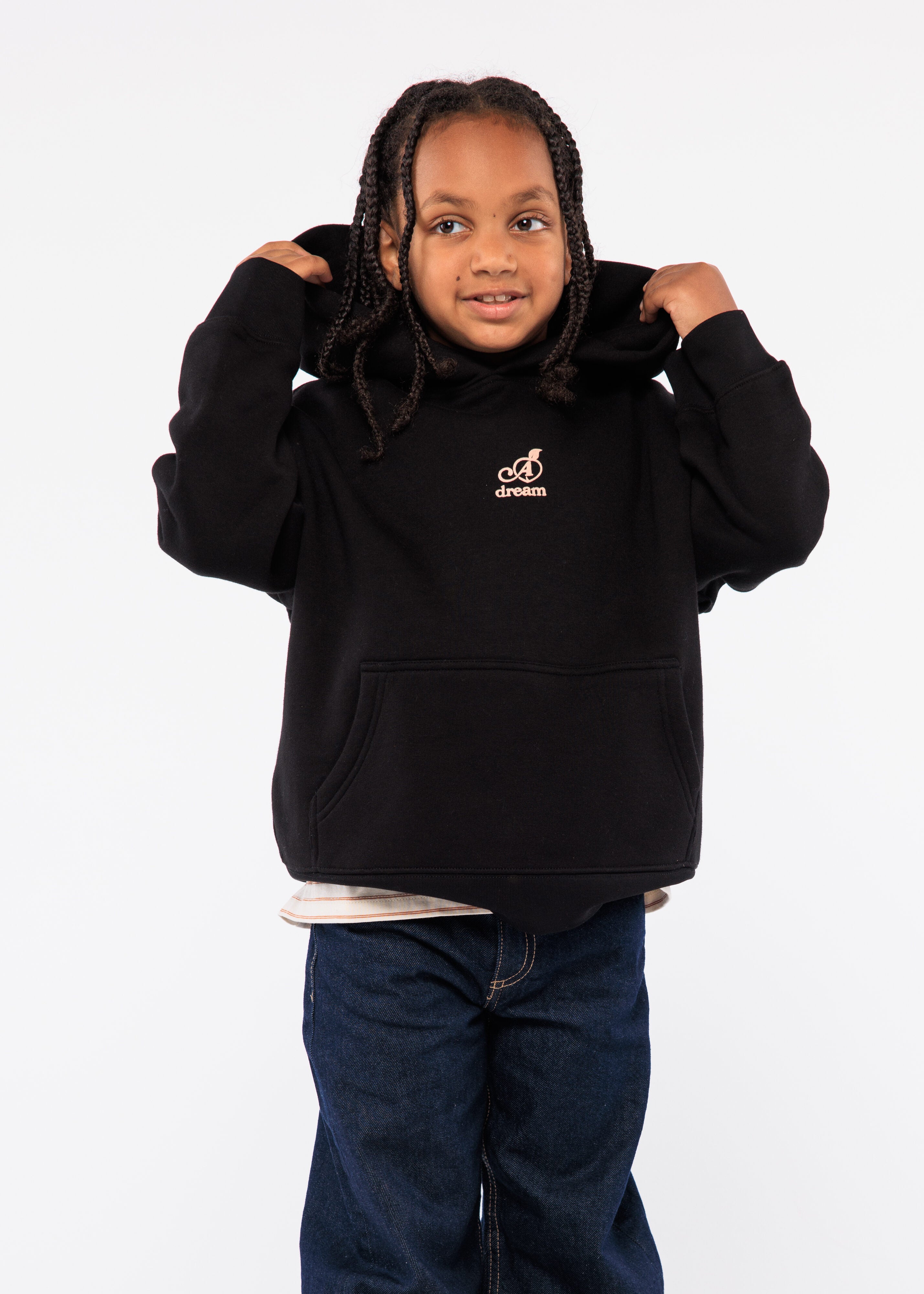 Child wearing a black hoodie with a logo 