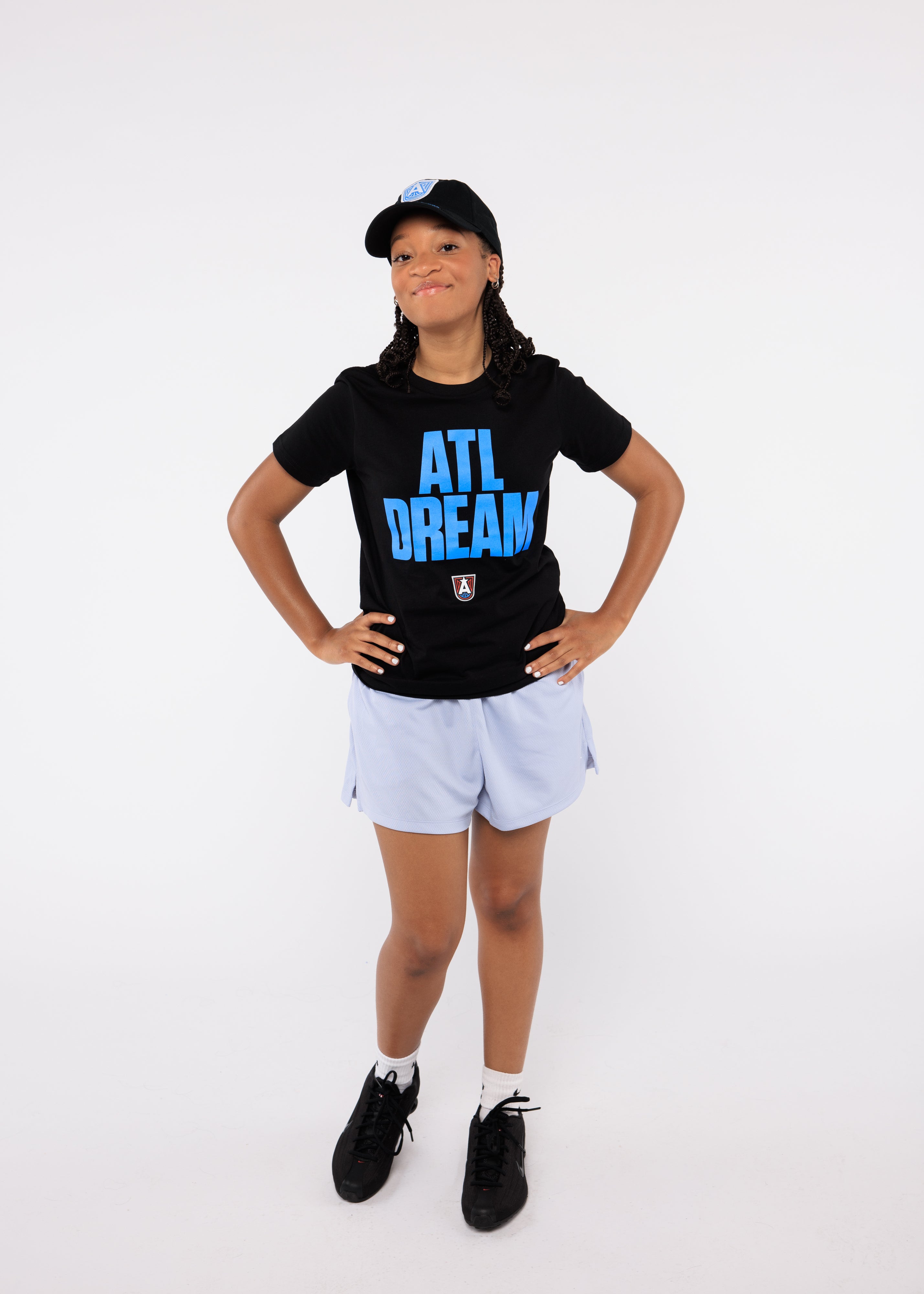 Wearing a black t-shirt with 'ATL DREAM' text and white shorts
