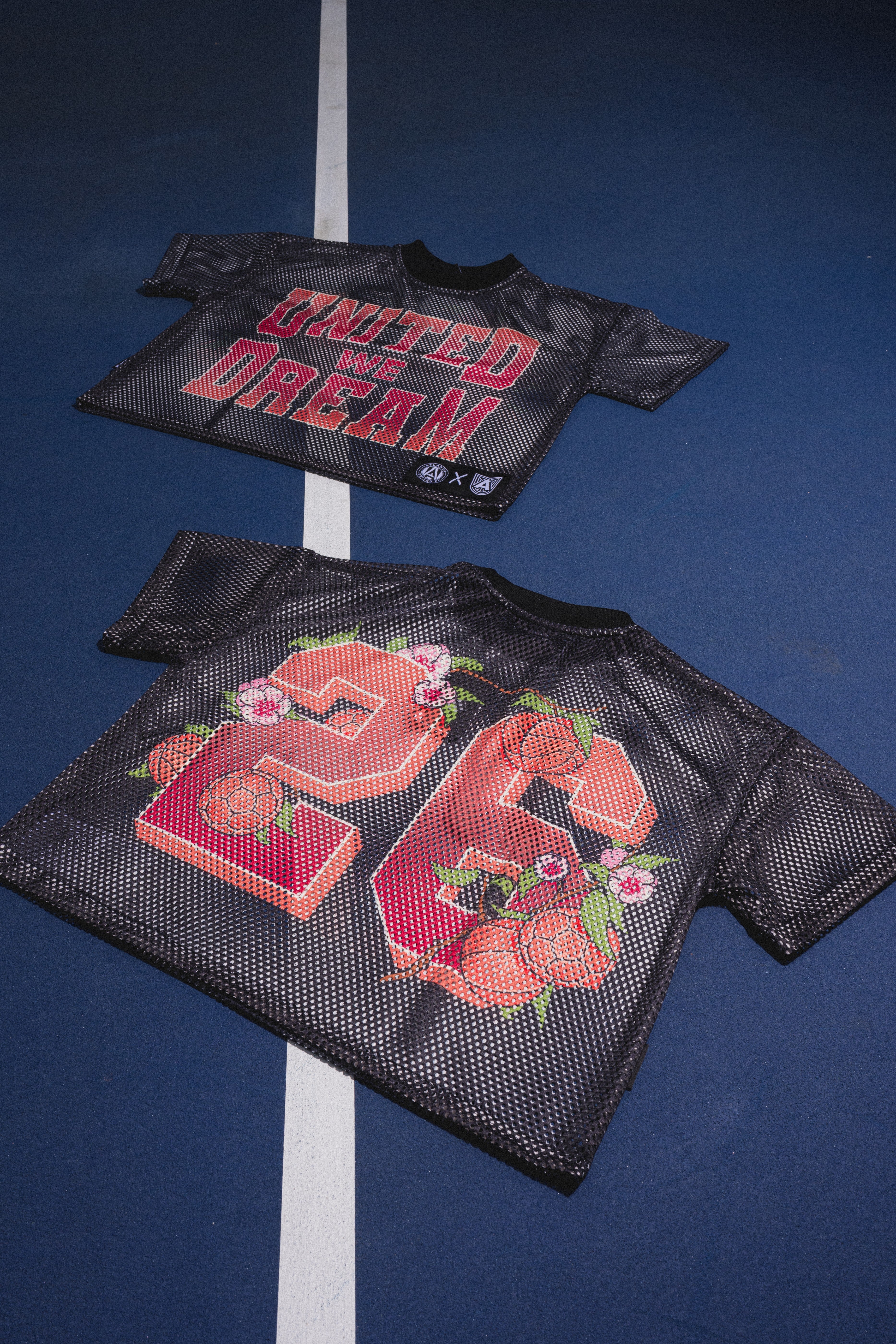 Two black mesh vests with text and floral designs 