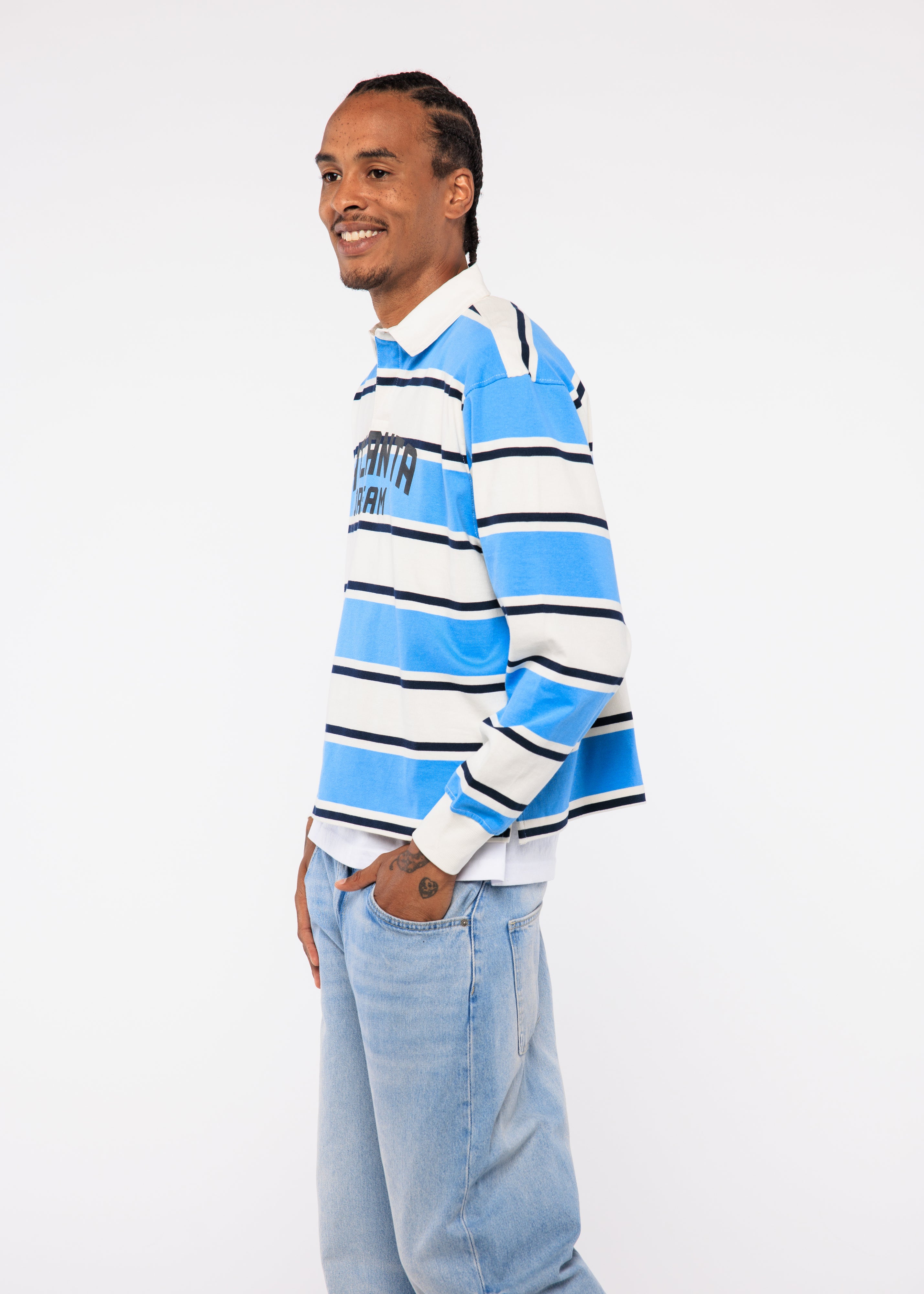 Wearing a blue and white striped sweater with a visible brand logo