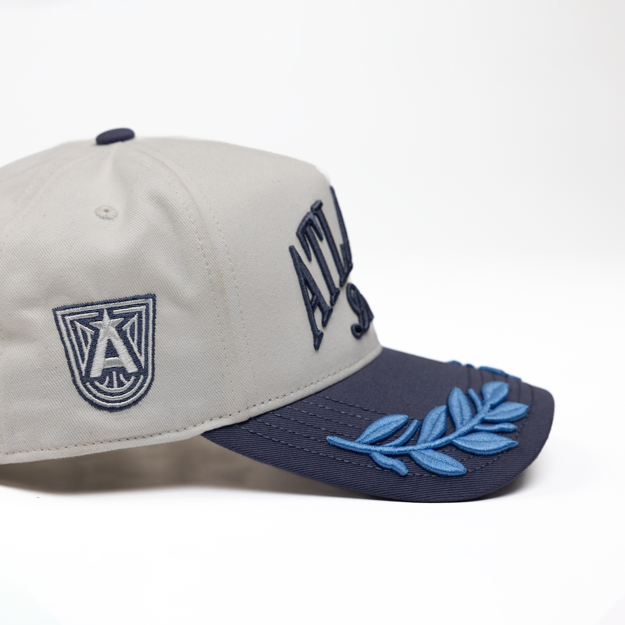 Two-tone cap with logo and leaf design 