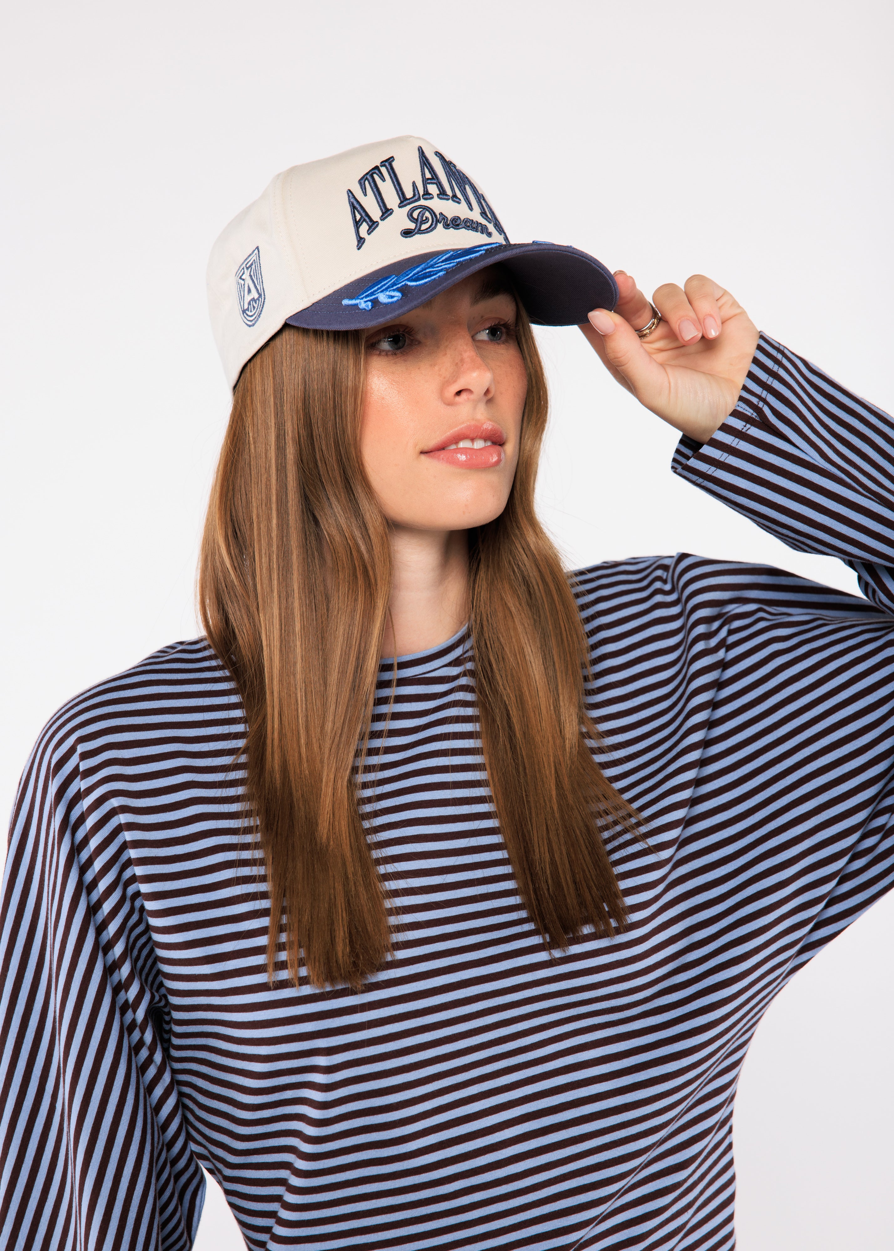 Woman wearing a cap with 'Atlanta Dream' branding
