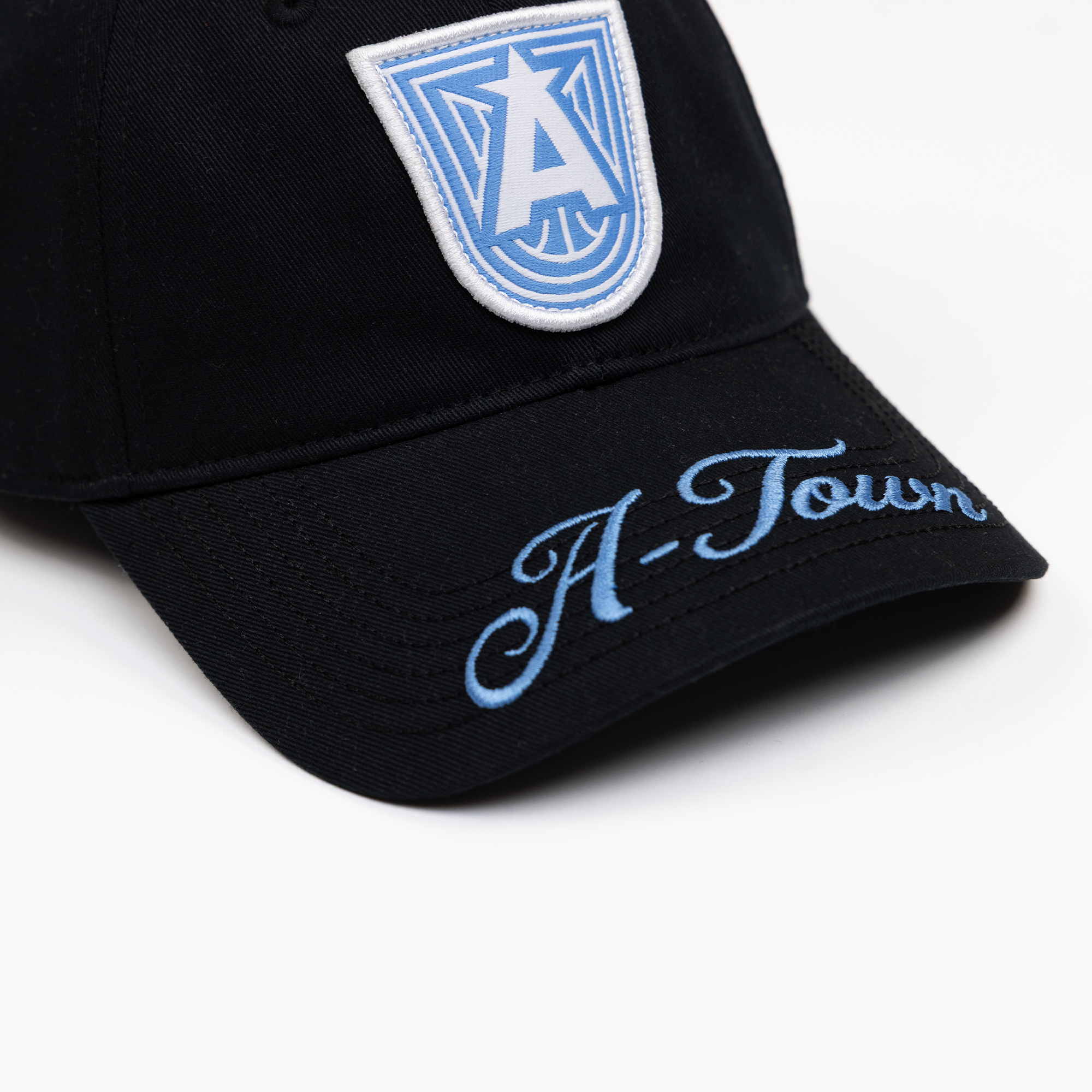 Black cap with blue logo and 'A-Town' text