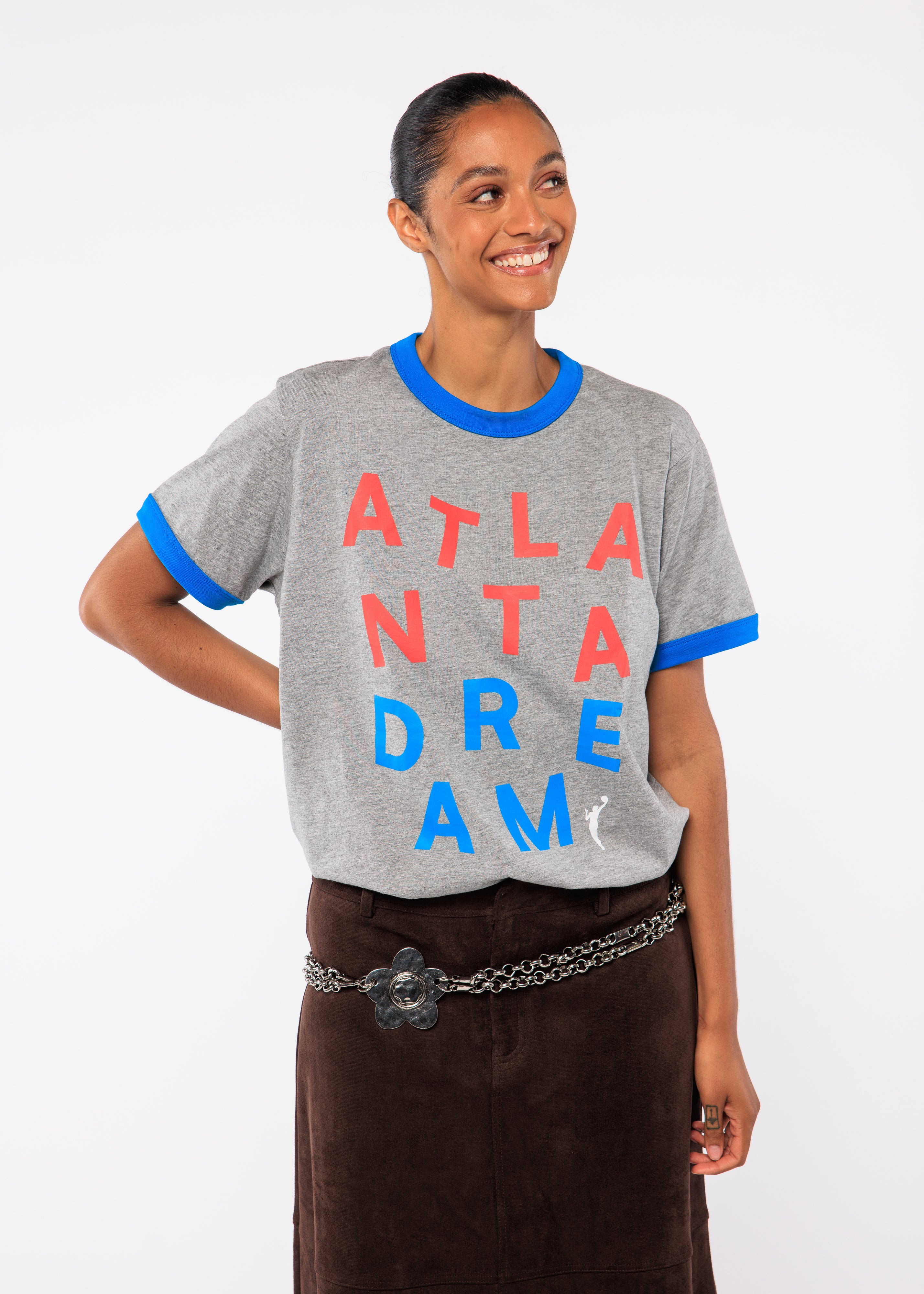 Woman wearing a gray t-shirt with colorful text 