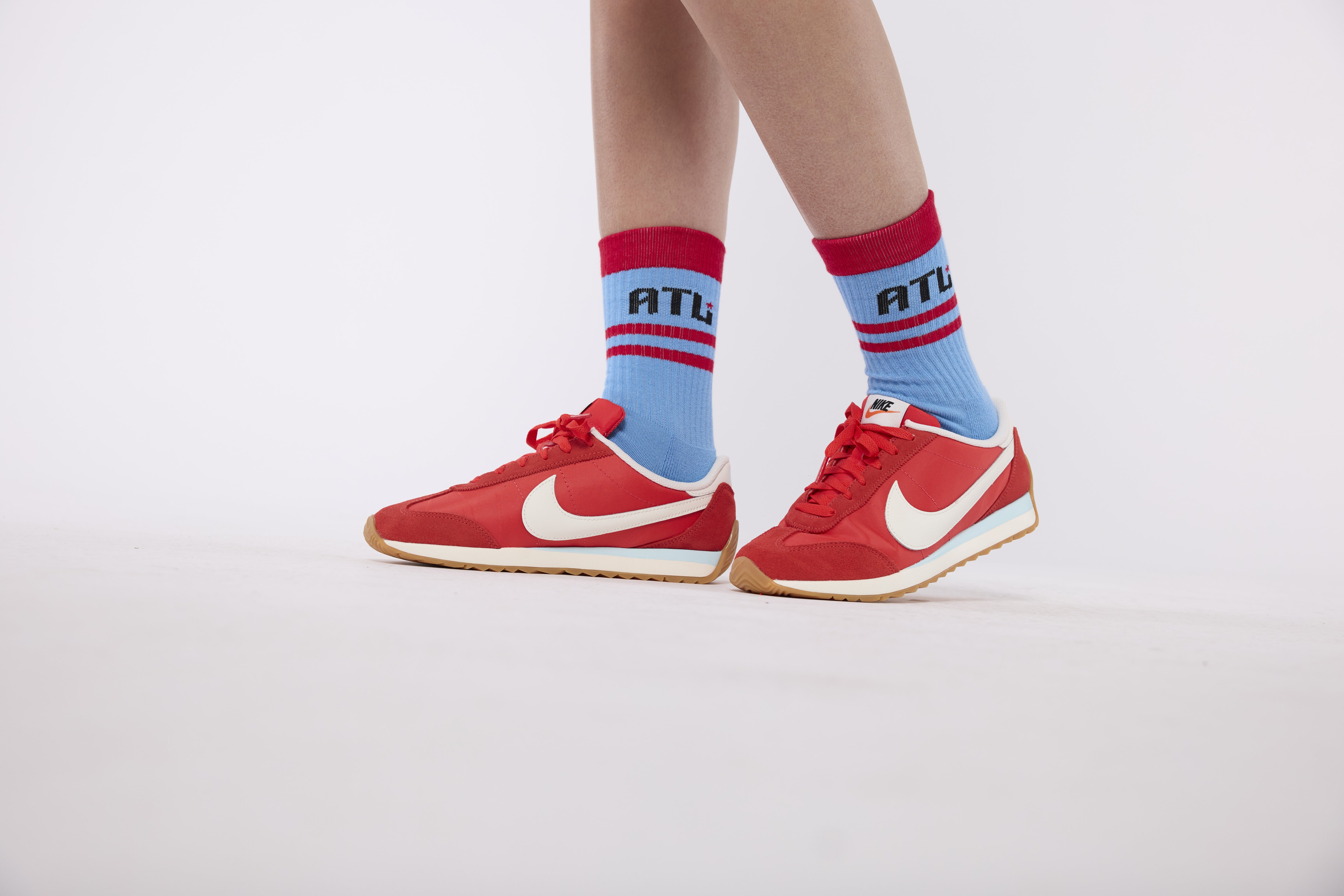 Red Nike sneakers with blue and red socks