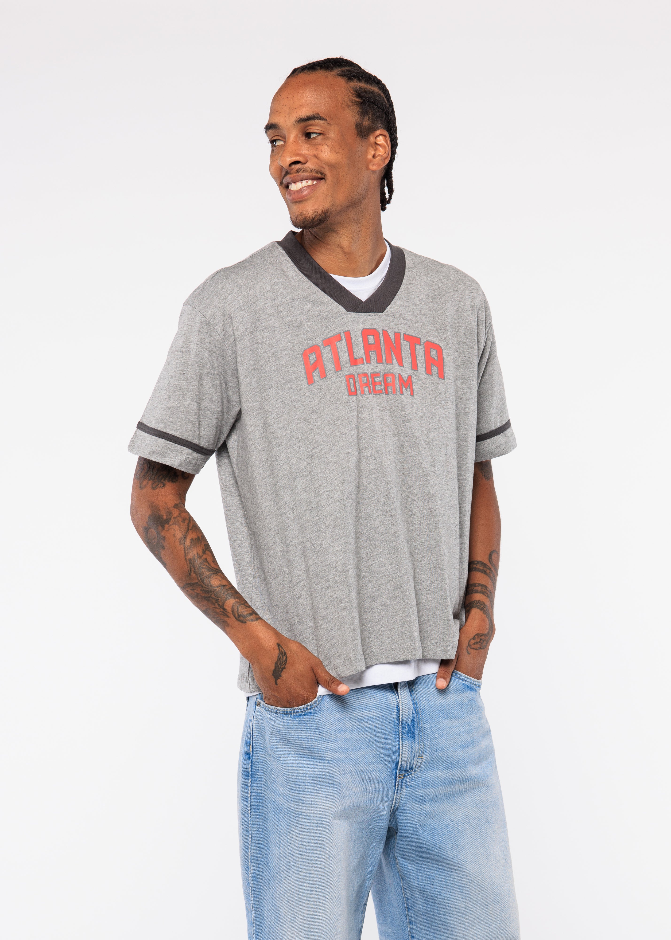 Wearing a gray 'Atlanta Dream' t-shirt with blue jeans