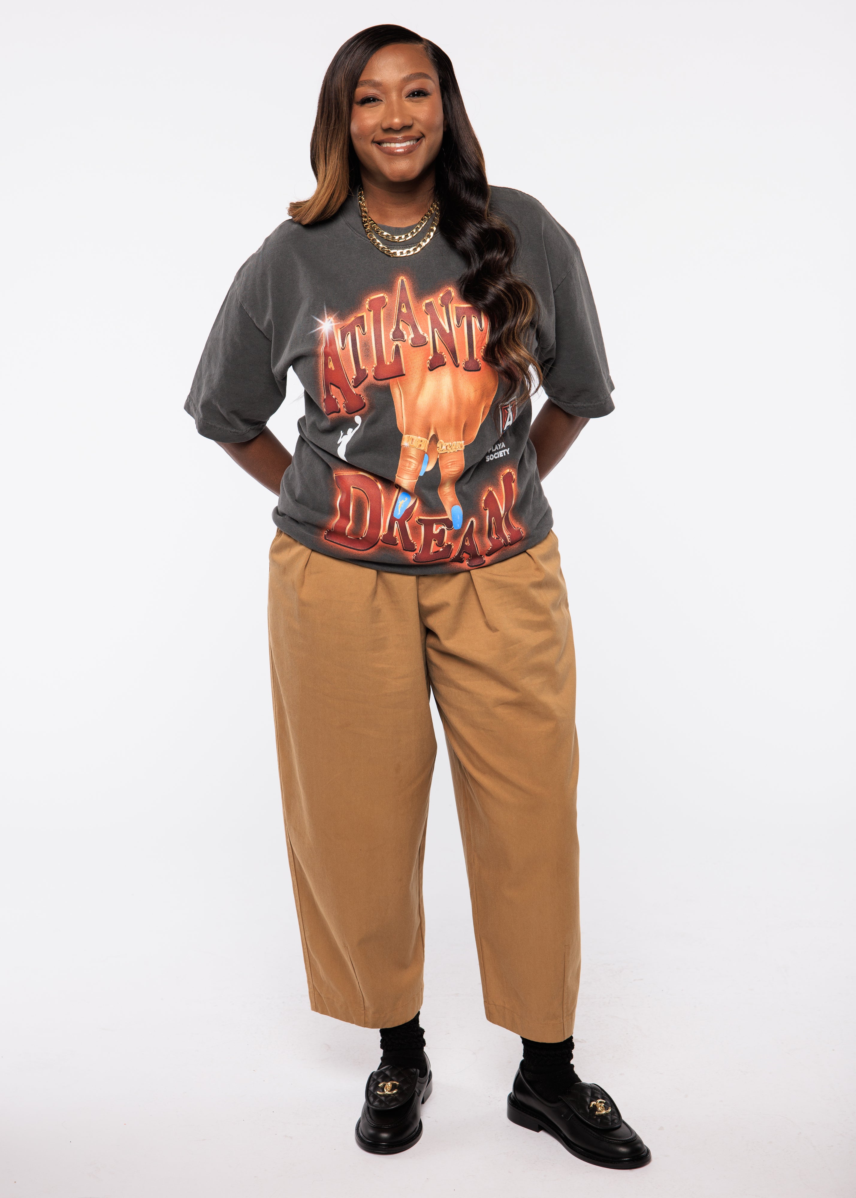 Wearing a graphic t-shirt and beige pants